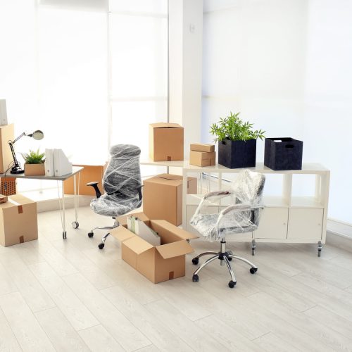 packed boxes and chairs in office